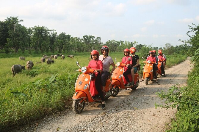 Beautiful Female Riders Vespa Red River Countryside Tour 5 Hours - Leaving Hanoi by vintage Vespa